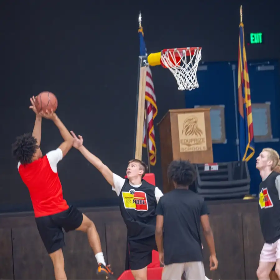 NBBL players at a no-backboard rim. Guardian release required before production if a minor is identifiable.