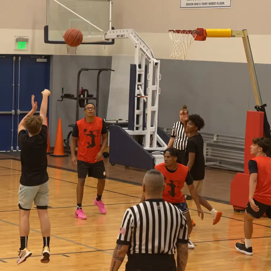 NBBL players at a no-backboard rim. Guardian release required before production if a minor is identifiable.