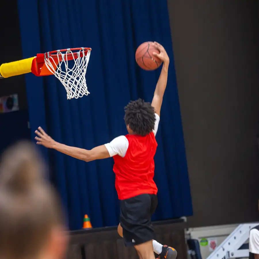 NBBL players at a no-backboard rim. Guardian release required before production if a minor is identifiable.